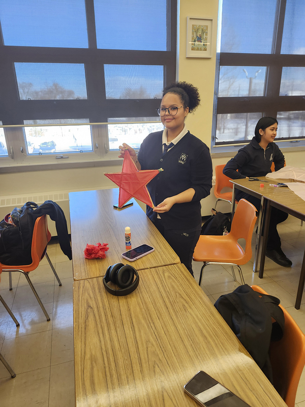 Photo of a student holding up the parol they made