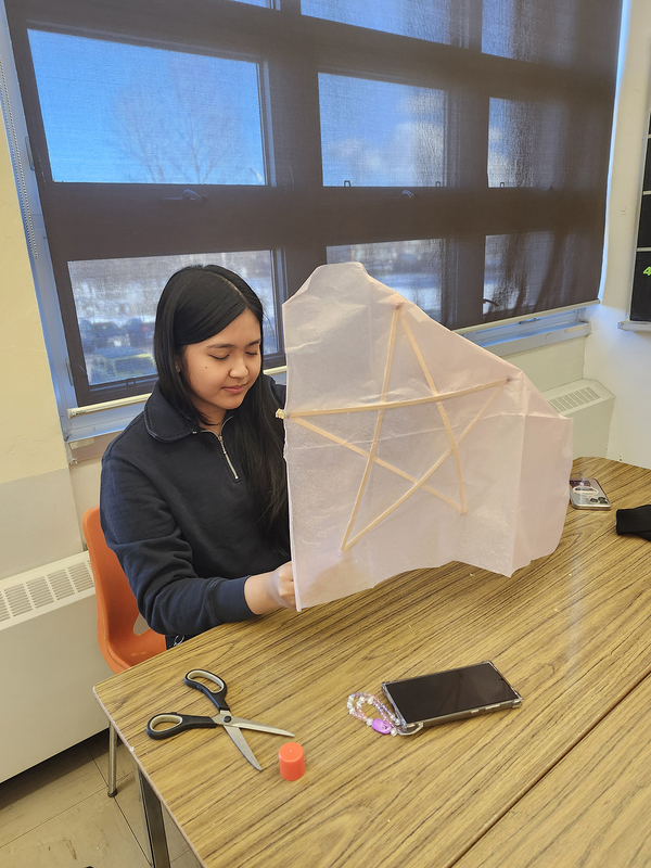 Photo of a student building their parol