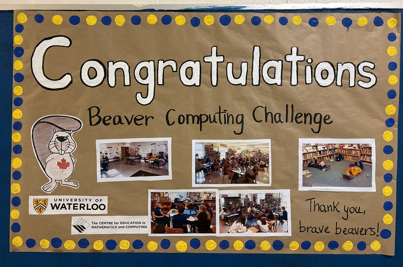 Photo of display congratulating St. Brigid students on completing the Beaver Computing Challenge, along with photos from the challenge