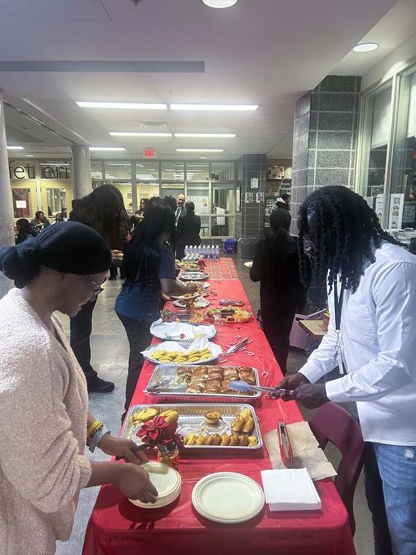 Photo of attendees taking food from a table set out during the event