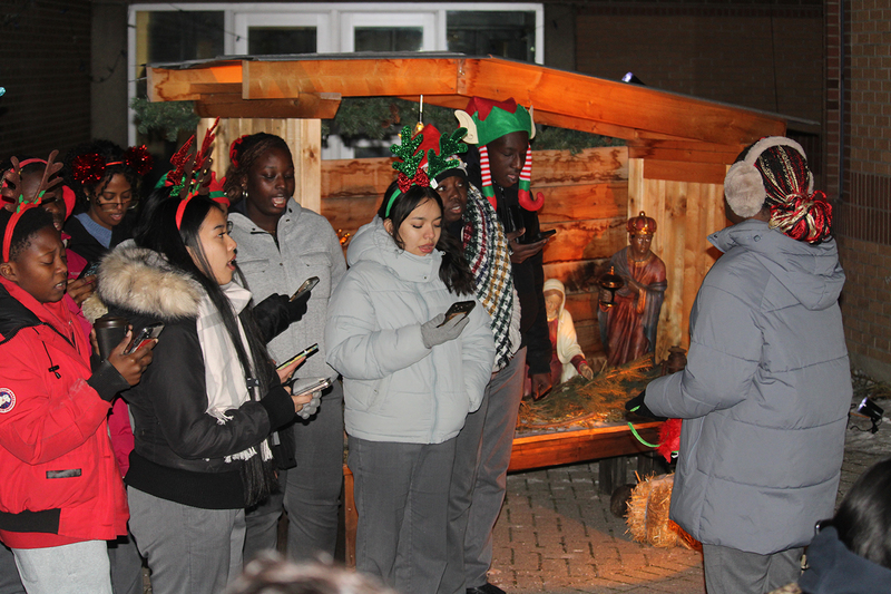 Photo of attendees at Father Henry Carr's Christmas in the Courtyard celebration