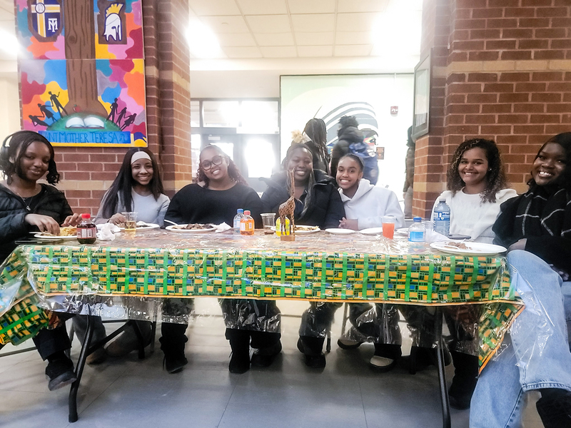 Photo of  students eating food together at the celebration