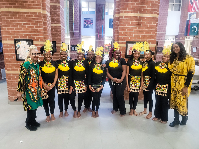 Group photo of students and staff in traditional attire
