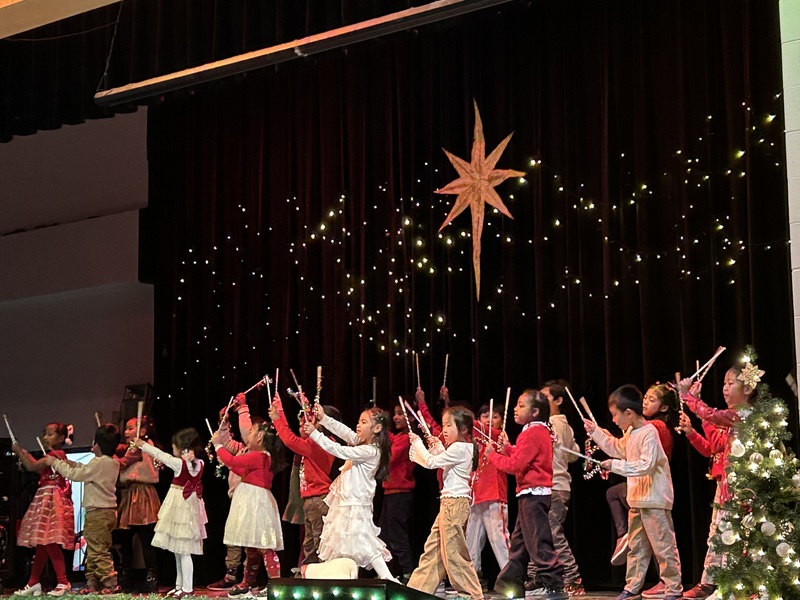 A group of young students performing on a stage for a Christmas play