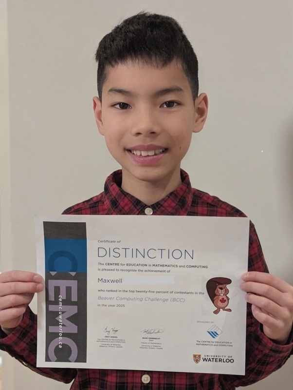 Photo of student holding up their certificate of achievement