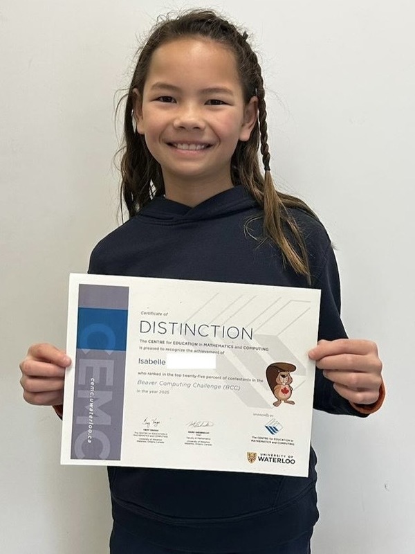 Photo of student holding up their certificate of achievement