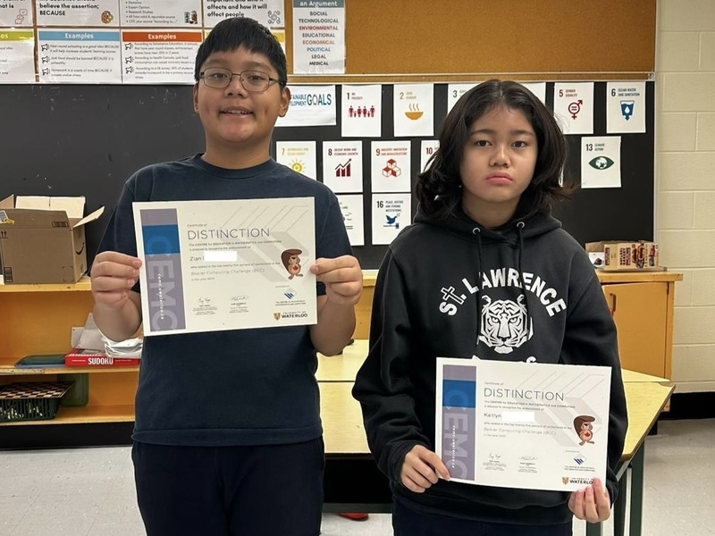 Photo of students holding up their certificate of achievement