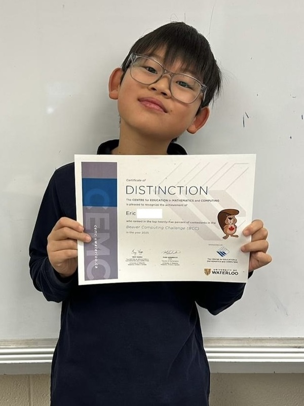 Photo of student holding up their certificate of achievement