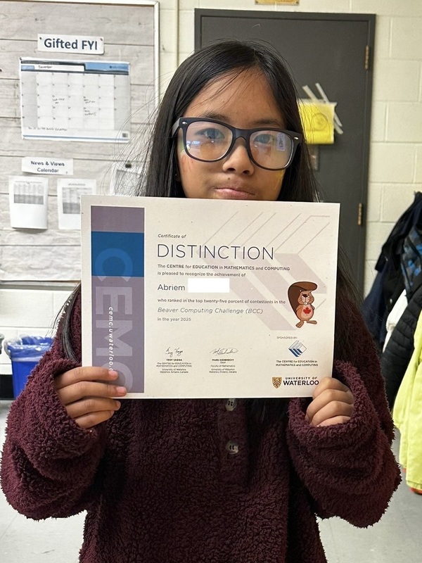 Photo of student holding up their certificate of achievement