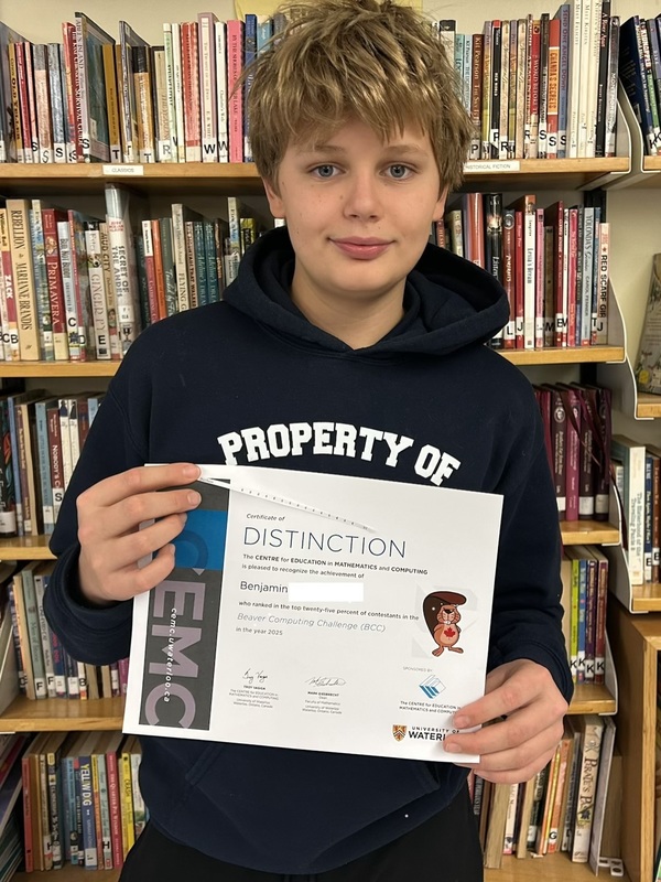 Photo of student holding up their certificate of achievement