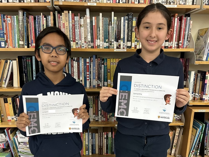 Photo of students holding up their certificate of achievement