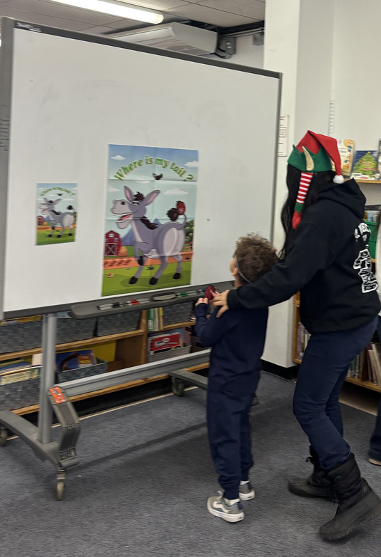 Photo of St. Benedict student and staff playing pin the tail on the donkey