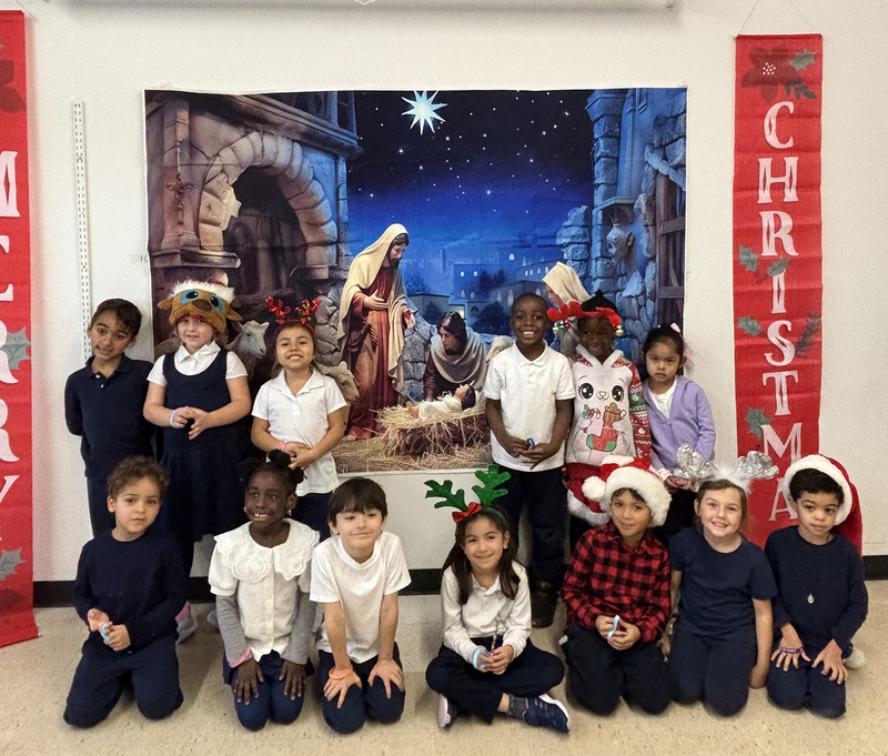 Photo of St. Benedict Kindergarten students in front of the Nativity painting