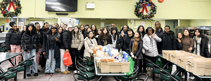 Group photo of Madonna students at Good Shepherd Ministries with their donated baked goods