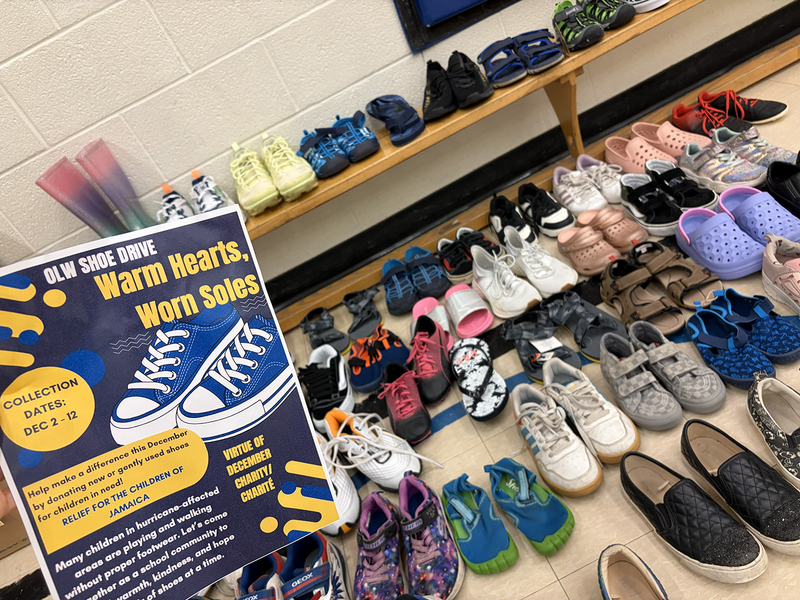 Photo of shoes collected with a flyer advertising the collection