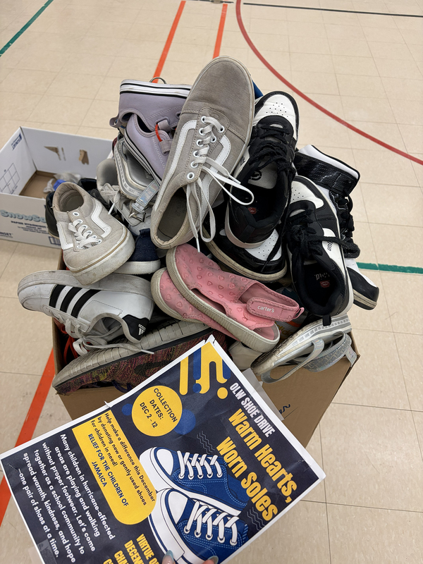 Photo of shoes collected with a flyer advertising the collection