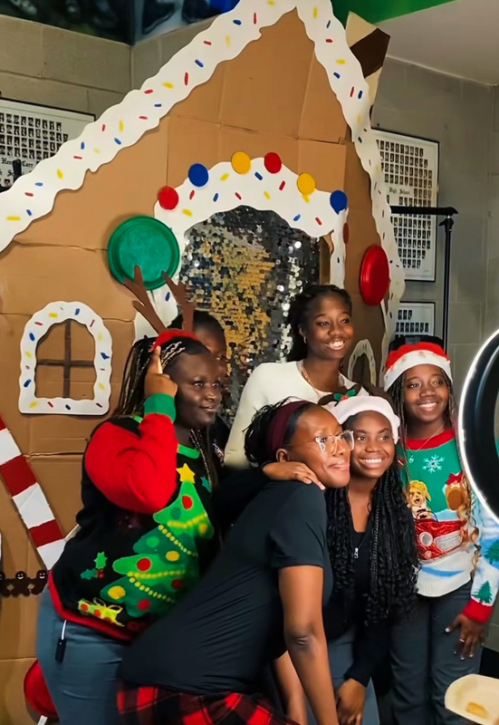 Photo of Father Henry Carr students posing together for a photo dressed in Christmas clothes and accessories