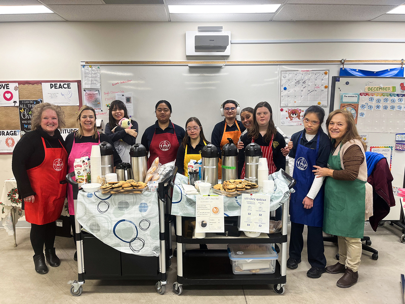 Photo of Loretto College students and teachers with their cart full of baked goods