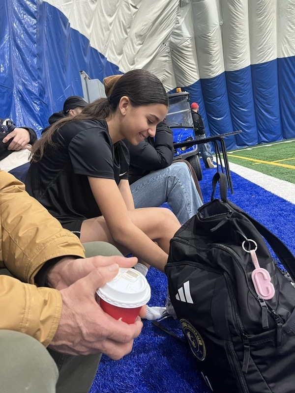 Photo of Cecilia sitting in the bleachers