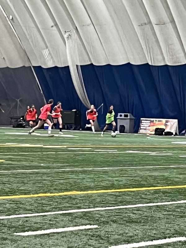 Photo of Cecilia playing on the soccer field