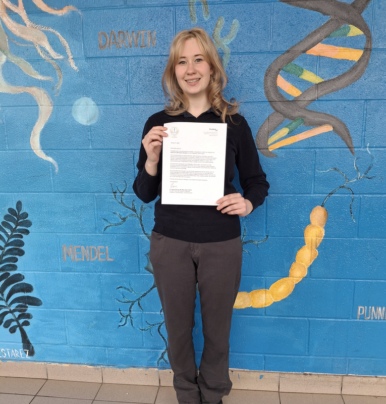 Photo of Sonya with her letter of award