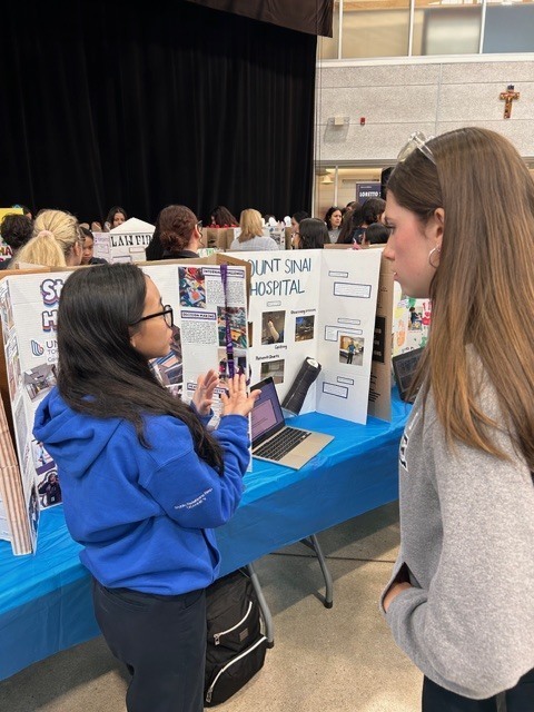 Photo of students at the fair with their presentation on their co-op experience