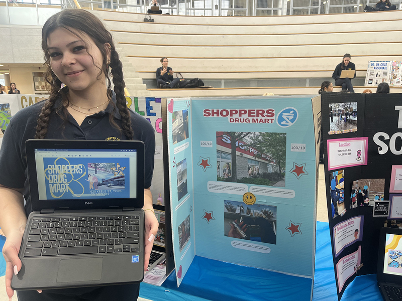 Photo of student at the fair with her presentation on her co-op experience at Shoppers Drug Mart