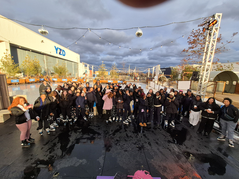 Group photo of Madonna students and staff in their skates