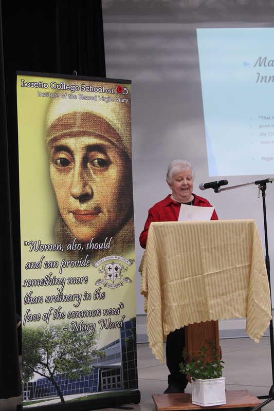 Photo of a Loretto sister speaking on the podium at the event