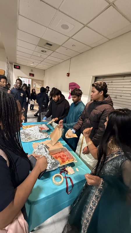 Photo of students taking food from food tables set out