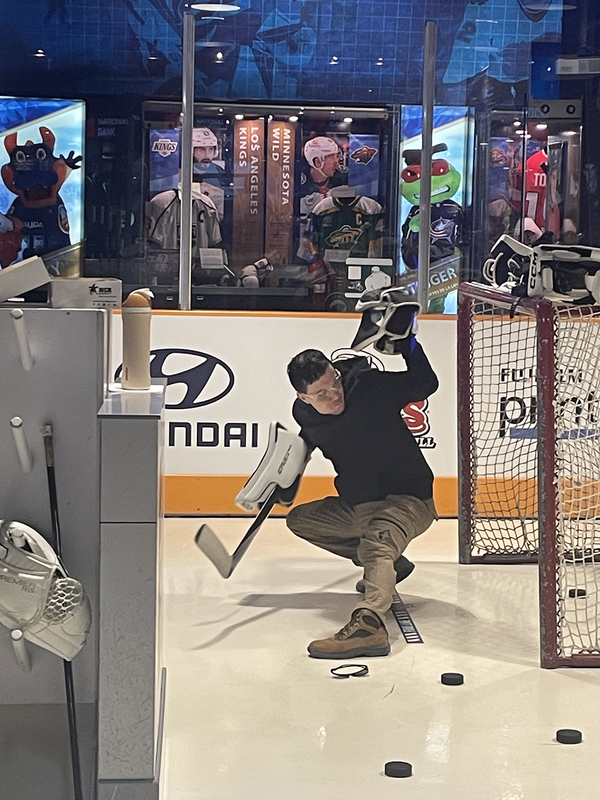Photo of students playing with the hockey equipment