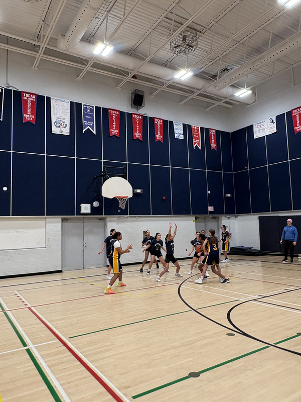 Photo of the teams playing on the court