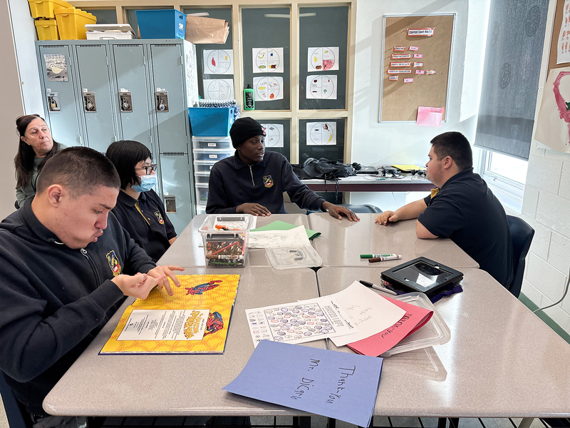 Photo of students reading together and conversing during the program