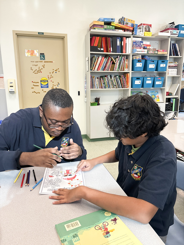 Photo of students coloring together