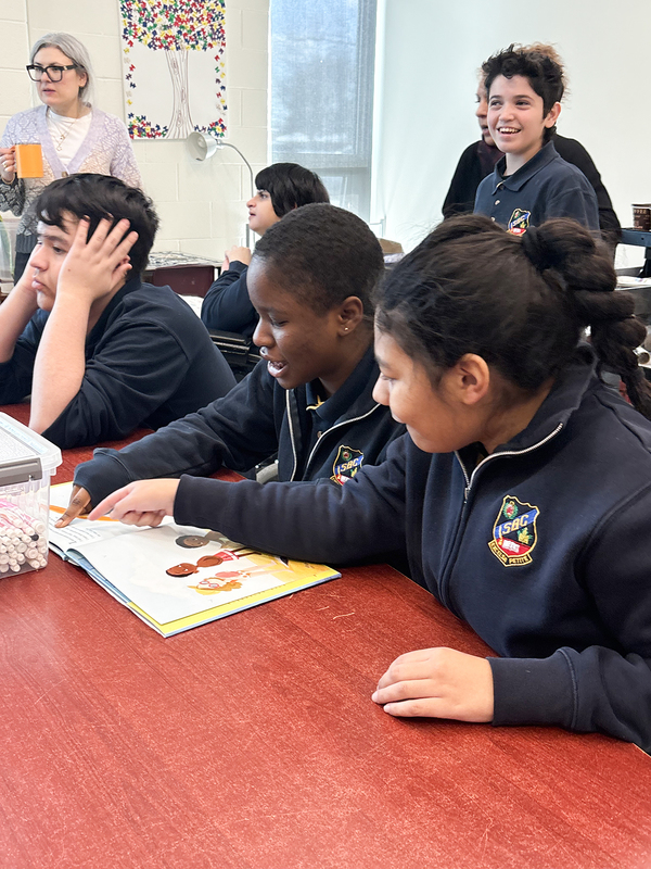 Photo of students reading together and conversing during the program