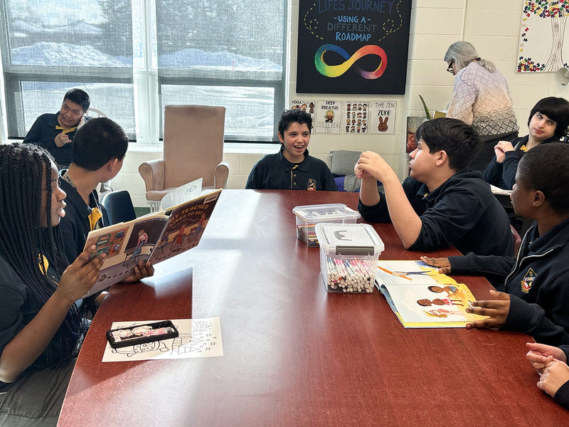 Photo of students reading together and conversing during the program