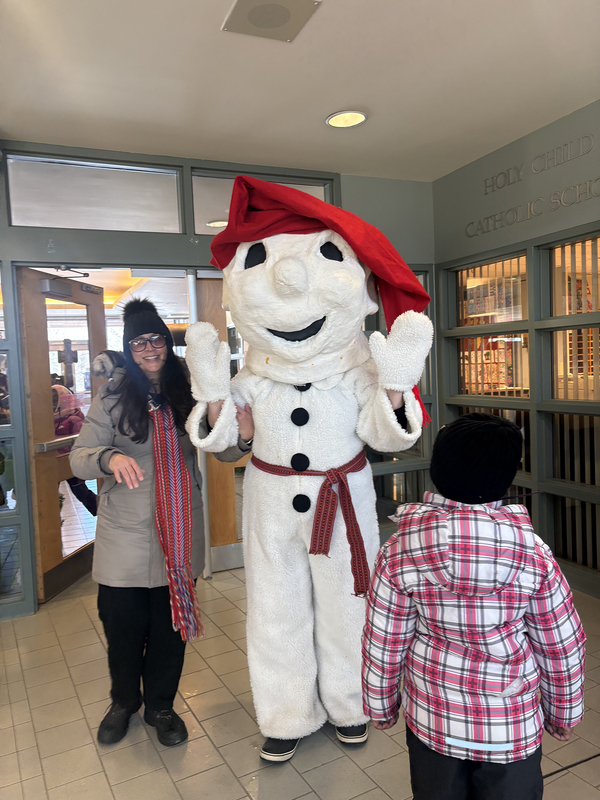 Photo of Holy Child staff member posing with Bon Homme the snowman