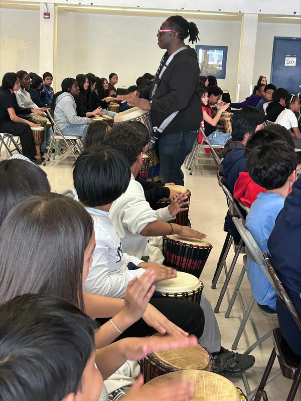 Photo of Mr. Babarinde Williams and the St. Margaret students drumming