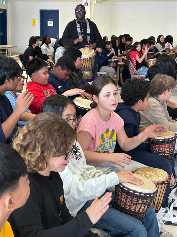 Photo of Mr. Babarinde Williams and the St. Margaret students drumming
