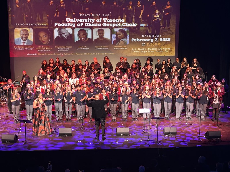 A large group of students performing music on a stage.