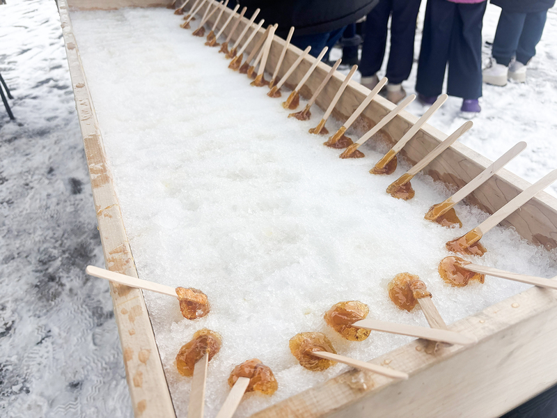 Photo of all the taffy resting in the box of clean snow