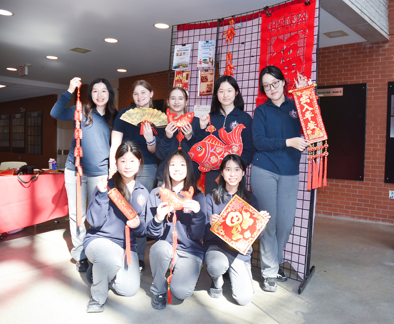 Photo of Redmond friends with Lunar New Year decorations and ornaments in red and gold