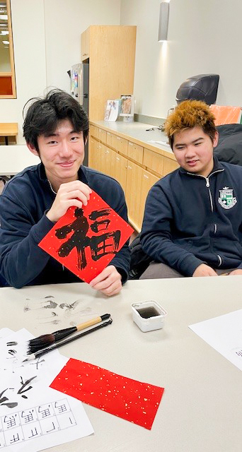Photo of Libermann students working on their calligraphy