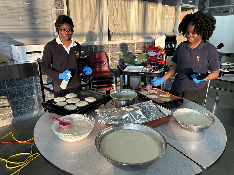 Photo of MPJ community members making pancakes