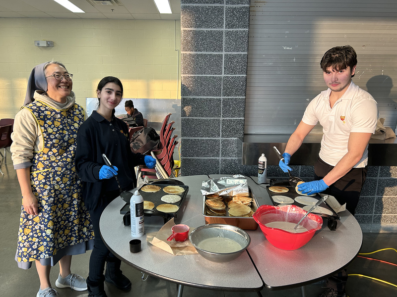 Photo of MPJ community members making pancakes