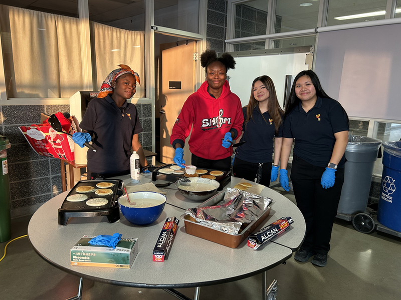 Photo of MPJ community members serving breakfast