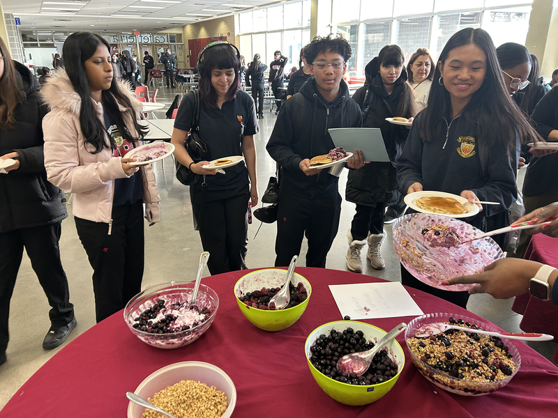 Photo of MPJ community members serving and getting breakfast
