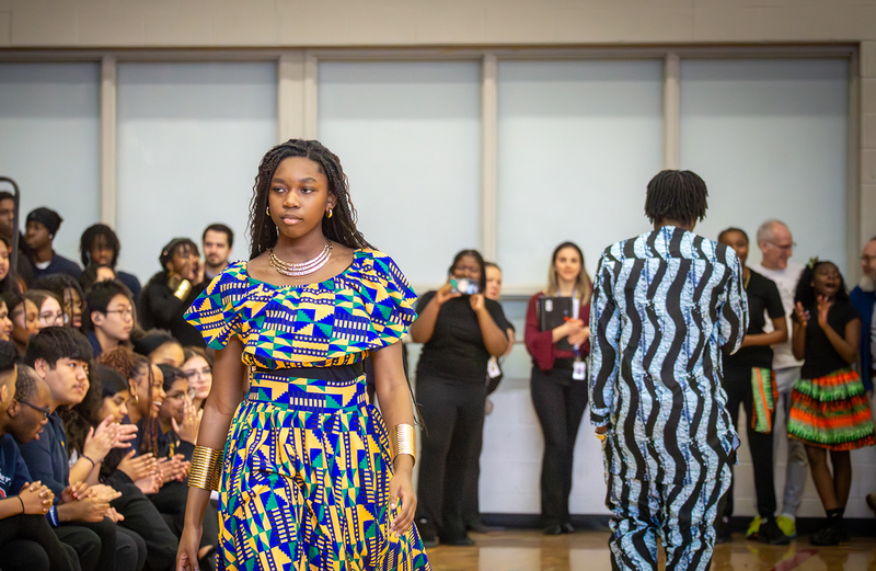 Student walking the runway at the Afro FLAME Fashion Show
