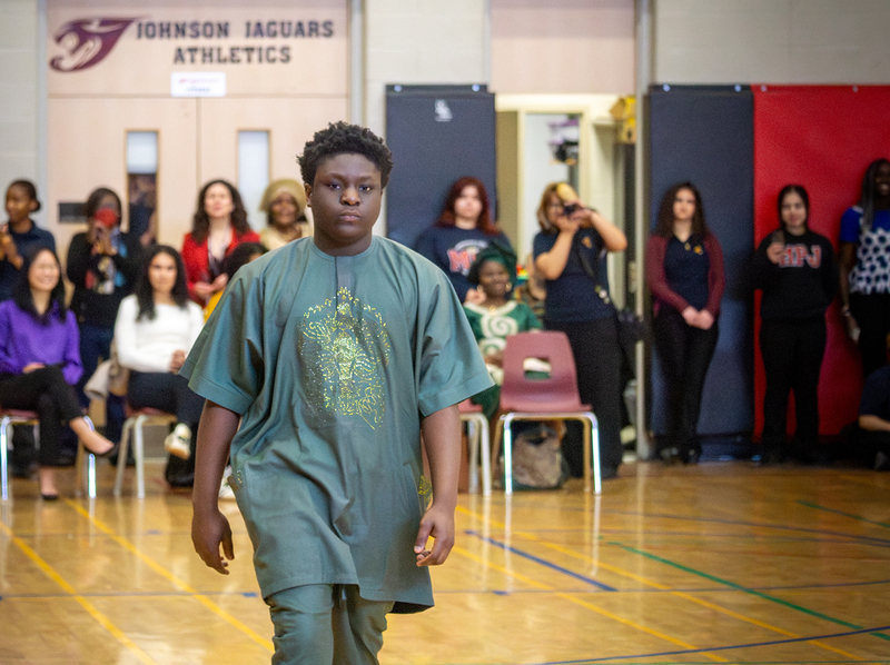 Student walking the runway at the Afro FLAME Fashion Show
