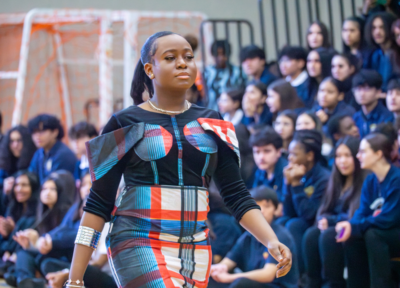 Student walking the runway at the Afro FLAME Fashion Show